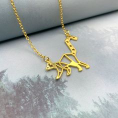 ◽ This charming lemur origami necklace is the perfect gift for animal lovers. ◽ Handmade with care, the necklace features a detailed lemur pendant made from gold-plated or silver-plated brass.  ◽ The necklace is also available in a variety of lengths, so you can find the perfect fit for your style. ◽ Whether you're looking for a unique gift for a friend or a special piece of jewelry for yourself, this lemur origami necklace is sure to please. PRODUCT FAQs ◽ The Pendant and chain materials are Go Hypoallergenic Gold Plated Necklace For Gift, Unique Gold Necklace For Mother's Day, Silver Animal Design Jewelry For Gifts, Silver Jewelry With Animal Design For Gift, Hypoallergenic Gold Plated Charm Necklaces As Gift, Hypoallergenic Gold Plated Charm Necklace For Gift, Gold Plated Nickel-free Charm Necklace For Gift, Hypoallergenic Yellow Gold Metal Necklace, Nickel Free Gold Plated Necklace For Gift