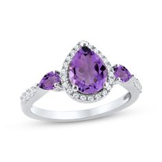 This dreamy ring showcases a gorgeous pear-shaped amethyst enveloped by shimmering round white lab-created sapphires at the center. Two smaller pear-shaped amethysts are set horizontally on the flanks for a vibrant and dynamic design. The band is further adorned in white lab-created sapphires, adding an extra touch of sparkle. The ring is crafted in classic sterling silver with a rhodium finish. Teardrop Rings With Diamond Accents, Elegant Teardrop Diamond Ring With Accent Stones, Formal Teardrop Amethyst Ring In Fine Jewelry Style, Elegant Pear-shaped Ring With Gemstone Accents, Elegant Pear-shaped Amethyst Ring For Formal Occasions, Elegant Formal Pear-shaped Amethyst Ring, Teardrop Shaped Brilliant Cut Jewelry For Promise Ring, Elegant Teardrop Ring With Gemstone Accents, Elegant Teardrop Rings With Gemstone Accents