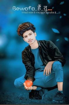 a young man holding an orange ball in his right hand while sitting on the ground