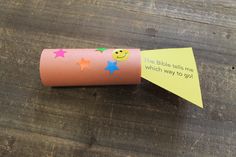 a toilet paper roll with a smiley face on it and a note attached to it