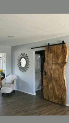 a living room filled with furniture and a large wooden piece of wood on the wall