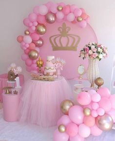 a pink and gold princess birthday party with balloons, cake, decorations and desserts