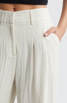 Soft pleats lend graceful movement to these high-waist pants designed with a crinkled texture and flowy wide legs. Zip fly with hook-and-bar closure 55% polyester, 37% viscose, 8% nylon Machine wash, dry flat Imported Chic Tapered Leg Rayon Pants, Chic White Rayon Bottoms, White Pleated Pants For Spring, Spring White Pleated Pants, White Wide-leg Rayon Pants, Elegant Wide Leg Rayon Pants With Relaxed Fit, Elegant Wide Leg Pants In Rayon With Relaxed Fit, White Rayon Wide-leg Pants, White Viscose Pants For Spring