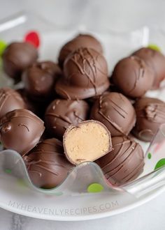 a plate full of chocolate covered candies with peanut butter in the middle on top