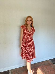 "The most flattering and adorable little faux wrap style dress; all over cream polka dot print with a fiery red underneath (warm toned red); overlay material is chiffon-like and is lightweight and has great movement; ruffle detailing at the neck with a self-tie belt at the waist; dress fit is fit and flare with the skirt being a circle skirt; zip closure in the back' tag reads a size 10 and fits true to size! for reference model is 5\"5, 34B cup size, pear shaped, and typically wears a small/med Polka Dot Flowy V-neck Dress, Flowy Polka Dot V-neck Dresses, Flowy V-neck Polka Dot Dress, Red Overlay, Pear Shaped Women, Fiery Red, Circle Skirt, Cup Size, Polka Dot Print