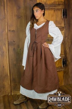 This surcoat is a versatile garment suitable for various character types. The skirt is wide, full, and ruffled at the waist, despite being short. It is made of high-quality, thick weft cotton, and it can be adjusted to size using the drawstring with loops in the back. The garment fastens at the front with drawstrings, making it easy to wear and adjust. Fall Long Sleeve Larp Costume, Medieval Style Dress For Fall Cosplay, Medieval Dress For Fall Cosplay, Brown Cosplay Dress, Long Sleeve Cotton Dress For Cosplay, Historical Costume Dresses For Fall, Medieval Dress For Larp In Fall, Curtain Skirt, Being Short