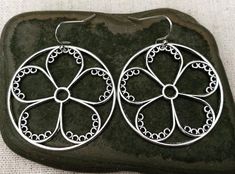 These are so unique and cool!  Big silver flower hoop earrings.  They are modern and whimsical.  Eye catching and versatile.  Dress them up or down.  The earrings measure 1 3/8” long by 1 3/8” wide and are made from plated silver.  They hang from simple silver ear wire hooks.  Overall drop length is 1 1/2”.I have a matching necklace in my shop if you would like the whole set.  Here is a direct link.........Thanks for stopping by!  Please take a moment and visit the rest of my Etsy store.  I have Hoop Earrings Big, Modern Hoop Earrings, Flower Hoop Earrings, Hoop Earrings Large, Silver Flower Necklace, Laser Engraved Ideas, Geometric Hoop Earrings, Earrings Big, Floral Hoops