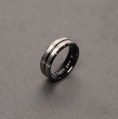 This all-black or Silver-black tungsten wedding band has been designed with a high polished channel groove that cuts through the center of the ring. We added a satin texture look on top of the ring running parallel with the polished center groove. This ring can be personalized with initials, words, dates, symbols... It's a perfect gift for your boyfriend, father, husband... simply your loved one. Perfect for any outfit or occasion. One of the most unique gift for him. ❥ Why choose this product ? Black Stainless Steel Promise Ring, Black Stainless Steel Promise Jewelry, Black Titanium Anniversary Rings, Black Titanium Jewelry Gift, Black Titanium Jewelry As Gift, Elegant Black Tungsten Carbide Rings, Modern Black Tungsten Carbide Jewelry, Mens Promise Ring Boyfriends, Promise Ring For Men