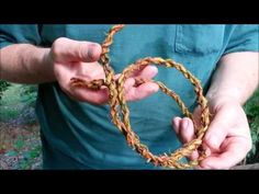 a man holding two pieces of rope in his hands