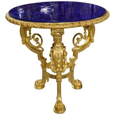 a blue marble topped table with gold accents