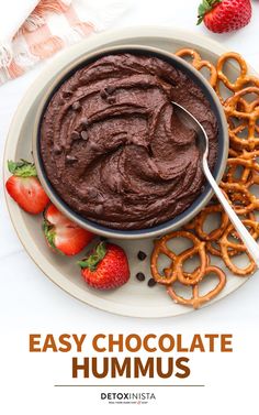 chocolate hummus in a bowl with strawberries and pretzels on the side