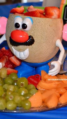 a close up of a plate of food with grapes and strawberries on the side