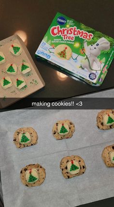 cookies with christmas tree decorations on them sitting next to a box of krispy kreme