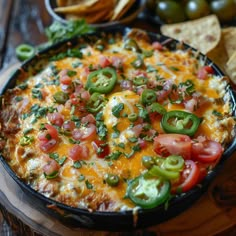 a black pan filled with mexican food and tortilla chips