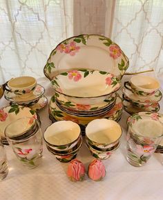 a table topped with lots of dishes and cups