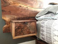 a bed with a wooden headboard next to a wall