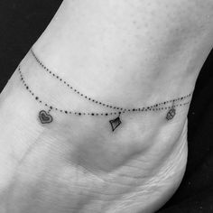 a black and white photo of a person's foot with tiny hearts on it