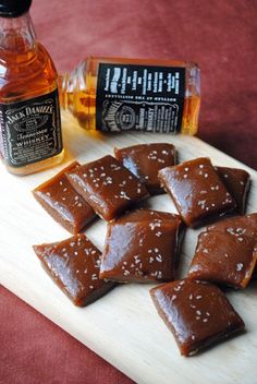 several pieces of fushi on a cutting board next to a jar of honey and a bottle of maple syrup