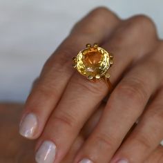 A lovely 10 carat oval citrine set in a wonderfully designed 18K yellow gold ring. The citrine is well cut has a great orangey color and is an immaculate looking stone.18K Yellow Gold Citrine 10tcw 16mm Band thickness 4.3mm Size 7.5 Resize available under request. Thank you for visiting our shop!Also, Follow us on Instagram https://www.instagram.com/dmkjewelryny/ Citrine Cocktail Ring, Ring Settings For Oval Stones, Orange Round Yellow Sapphire Jewelry, Faceted Yellow Gold Topaz Ring For Wedding, Yellow Topaz Round Ring, Yellow Oval Topaz Ring In 14k Gold, Yellow Gold Topaz Ring With Yellow Sapphire, Oval Yellow Topaz Ring In 14k Gold, Elegant Round Topaz Ring With Yellow Sapphire