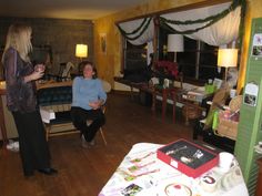 two women standing in a living room talking to each other