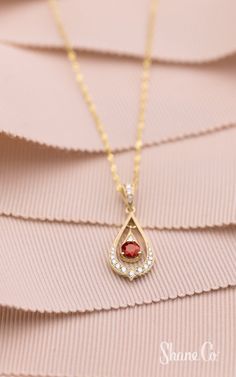 This ruby pendant is radiant. Crafted in quality 14k yellow gold, one round ruby and 17 round diamonds come together to create this lovely pendant. Hanging from an 18″ Singapore chain, this beautiful vintage-inspired pendant is secured by a lobster clasp. The total gem weight is approximately .40 carat. Article Number: 41084851 Elegant Ruby Teardrop Pendant Necklace, Elegant Yellow Gold Drop Necklace With Birthstone, Elegant Birthstone Drop Necklace In Yellow Gold, Elegant Yellow Gold Birthstone Drop Necklace, Yellow Gold Ruby Teardrop Necklace, Yellow Gold Teardrop Ruby Necklace, Teardrop Ruby Jewelry In Yellow Gold, Red Teardrop Jewelry With Diamond Accents, Teardrop Ruby Necklace In Yellow Gold