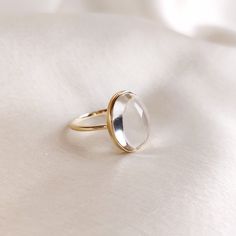 This stunning ring is set in 14k Solid Yellow Gold with Natural Clear Quartz with utmost precision. It is an unique statement gemstone ring for nearly every occasion and is completely hassle-free jewelry. 🔷ABOUT GEMSTONE: Clear quartz, often referred to as the "Master Healer," is a pristine, transparent variety of quartz renowned for its pure energy and versatility. Its crystal clarity represents clarity of mind, and it is believed to amplify the properties of other gemstones. It serves as a po Modern Oval Moonstone Ring In Yellow Gold, Modern Oval Yellow Gold Moonstone Ring, Modern Yellow Gold Oval Moonstone Ring, Luxury Oval Moonstone Anniversary Ring, Modern Oval Moonstone Ring For Formal Occasions, Modern 14k Gold Oval Cabochon Rings, Formal Rings With Si Clarity, Round Shape, Modern White Gold Dome Ring As Gift, Modern Crystal Ring With Oval Gemstone