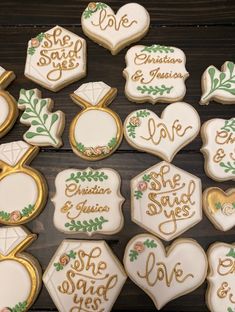 decorated cookies are arranged in the shape of hearts and love letters on a wooden table