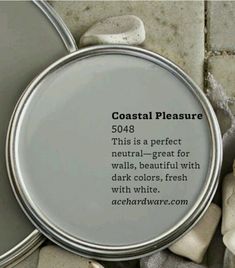 there is a tin with some white paint on it and the words coastal pleasure written in black