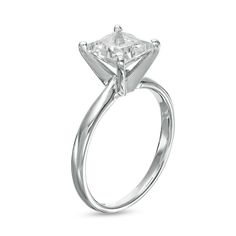 a princess cut diamond engagement ring on a white background with the center stone set in 18k white gold