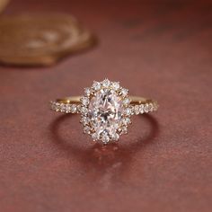 an oval shaped diamond ring on a table