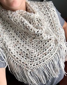 This scarf is made with beautiful off white yarn with specks of neutral throughout. This scarf is definitely unique and gives off a boho vibe with its off white coloring and fringe. This scarf can be worn as a beautiful accessory to show off your fashion sense, or can be worn in the winter months looped around the neck 2x to keep you nice and warm.  I really enjoy the vibe this scarf gives off and whenever I wear my personal one I am always receiving compliments. So if you are looking for a fun and unique gift for your stylish friend/sister/coworker/girlfriend/wife this is the scarf you are looking for.  This scarf is only shown in one color as that is what I have in stock currently, but it can be made to order in several colors.  Any questions? Don't hesitate to send me a message. White Bohemian Scarf For Fall, White Bohemian Scarf One Size, White Bohemian Hand Knitted Scarves, Bohemian White Hand Knitted Scarves, Bohemian Cream Scarves For Winter, Bohemian White Hand Knitted Scarf, Bohemian White Hand-knitted Scarf, Bohemian Crochet Yarn Scarves, White Crochet Bohemian Scarves