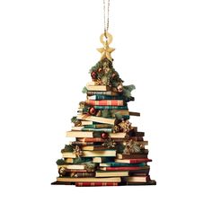 a christmas tree made out of books is hanging on a chain with an ornament