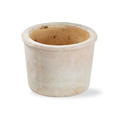 a white ceramic cup with brown speckles on the outside and inside, sitting in front of a white background