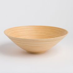 a wooden bowl sitting on top of a white table