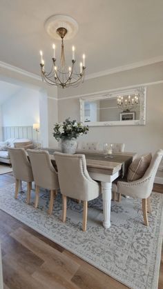 the dining room table is surrounded by beige chairs