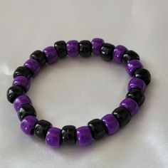 Introducing our handmade Halloween-Themed Purple and Black Beaded Bracelet - a stylish and spooky accessory perfect for celebrating the season! Crafted with deep purple and bold black beads, this bracelet captures the essence of Halloween in a subtle yet striking way. Whether you're getting into the spooky spirit or simply adding a fun touch to your fall wardrobe, this bracelet is sure to make a statement. As a small business owner, I handcraft each piece with care, ensuring that every bracelet is made with attention to detail and designed to last. Wear it on its own for a sleek Halloween vibe, or stack it with other pieces for a more layered, festive look. Whether you're treating yourself or gifting it to a Halloween lover, this bracelet is the perfect accessory for the season. Thank you Black Wristband With Colorful Beads Gift, Purple Beaded Bracelets With Black Beads As A Gift, Adjustable Purple Bracelets With Black Beads, Adjustable Purple Bracelet With Black Beads, Black Round Bead Bracelets For Halloween, Black Beaded Bracelets For Halloween, Black Round Beaded Bracelets For Halloween, Halloween Black Bracelets With Round Beads, Handmade Black Wristband For Halloween