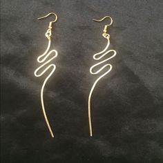 pair of earrings with spiral design on black background