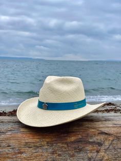 Ocean Western is a Southern-inspired Panama hat made for the long haul. It features a 3 ½” stiffened brim with raised edges and a wire to hold its shape. Handwoven from 100% Toquilla straw and finished with a handcrafted leather hatband, teardrop pinched crown and a sea turtle pin for details. The Ocean Western Panama hat was created with the purpose of donating 5% of each Ocean Western sold to the Sea Turtle Conservancy, the world’s oldest sea turtle research and conservation group that carries Fitted Panama Hat For Western-themed Events, Fitted Wide Brim Panama Hat For Beach, Woven Toquilla Straw Fedora With Flat Brim, Country Style Short Brim Hat In Toquilla Straw, Country Style Straw Hat With Short Brim For Travel, Flat Brim Toquilla Straw Hat For Travel, Country Style Short Brim Straw Hat For Travel, Natural Brimmed Hat For Ranch, Country Style Short Brim Toquilla Straw Hat