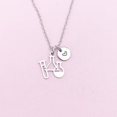 This is a silver-tone Science Laboratory Beakers charm with hand stamped initial charm on stainless steel necklace. ♥ You will receive ONE necklace. HOW TO ORDER 1) Choose the quantity. 2) Choose the initial and finish in the option or add a note to seller at checkout. 3) Add to the cart. DESCRIPTION ♥ Necklace, Stainless Steel Chain with Lobster Claw Clasp, Size: about 17.7 inches (45cm) long, 1-2mm wide, Nickel Safe,  ● The stainless steel is durable, highly resistant to water, rust and corros Silver Hand Stamped Meaningful Charm Necklace, Silver Stamped Charm Necklaces For Valentine's Day, Silver Stamped Charm Necklace For Valentine's Day, Valentine's Day Silver Stamped Charm Necklaces, Hand Stamped Silver Stainless Steel Charm Necklaces, Silver Stainless Steel Charm Necklace For Personalized Gifts, Silver Stainless Steel Charm Necklaces For Personalized Gifts, Personalized Silver Stainless Steel Charm Necklaces, Silver Stamped Charm Necklace For Birthday