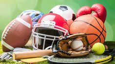 various sports equipment on the grass with green background