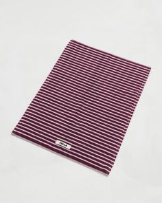 a red and white striped cloth on a white surface