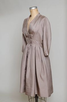 "1950s Modern Silk Camel Brown Anjac Fashions California Button Down Shirt Dress Camel brown silk, this dress has a beautiful modern cut. Gathered waistline, with a batwing cut. Anjac of California. Measurements shoulders: free chest: 39\" waist: 27\" length: 42.5\"" Elegant A-line Vintage Dress With Buttons, Elegant A-line Vintage Dress For Daywear, Formal Silk Button-up Dress, Formal Button-up Silk Dress, Silk Button-up Evening Dress, Button-up Silk Evening Dress, Elegant Silk Dresses With Button Closure, Classic Silk Dresses With Buttons, Silk Button-up Dresses For Daywear