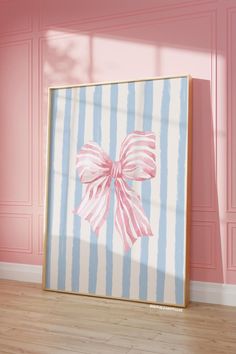 a pink and blue striped wall with a bow on it