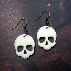 Show the world your scary side when you wear these Dangerously Cute Skull Pendant Dangle Earrings! 💀 These noticeably striking Skull Pendant Earrings are made of laser cut Ivory Color Acrylic! So lightweight, your real skull will hardly feel them! 💀 These Skull Earrings measure about 1″ tall and hang off your choice of earring hooks! Pick from: ~ Nickel Free (Shown in Pictures) ~ Stainless Steel Hooks ~ Plastic Hooks ~ Clip Ons ~ Titanium Hooks 💀 Adorable Skulls make great presents! Give thes Halloween Skull Jewelry With Skull Print, White Gothic Skull Jewelry, Halloween Skull Jewelry In Bone Color, Halloween Skull Shaped Bone Jewelry, White Skull-shaped Halloween Jewelry, Halloween Skull Jewelry In White, White Skull Jewelry For Halloween, Halloween White Skull Jewelry, Halloween Skull Print Earrings