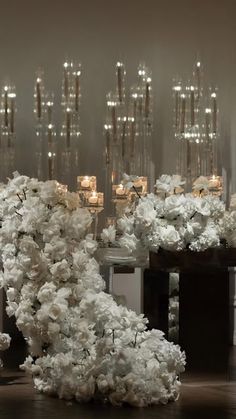 white flowers and chandeliers in a room