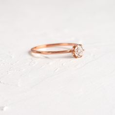 a diamond ring sitting on top of a white surface