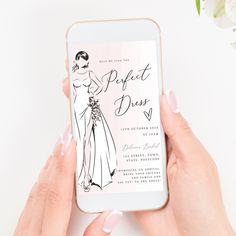 a woman's hands holding an iphone with a wedding card on the screen next to flowers