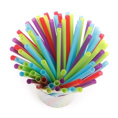 many different colored straws in a glass vase