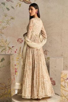 Ivory anarkali with botanical print and thread, sequin, tassel embroidered yoke and pleated detailing. Paired with embroidered dupatta.
Components: 2
Pattern: Printed, Embroidery
Type Of Work: Botanical, thread, sequin, tassel
Neckline: Plunge V neck
Sleeve Type: Churidar sleeves
Fabric: Anarkali: Chiffon, Dupatta: Net, Organza
Color: Ivory
Other Details: 
Ruffle border embroidered dupatta
Occasion: Sangeet - Aza Fashions Elegant Lehenga With Printed Motifs, Elegant Dupatta With Printed Motifs For Reception, Elegant Printed Dupatta For Reception, Elegant Reception Dupatta With Printed Motifs, Elegant Silk Anarkali Set With Floral Print, Beige Anarkali Gown With Sheer Dupatta, Beige Floor-length Gown With Sheer Dupatta, Elegant Semi-stitched Anarkali Set With Floral Print, Elegant Anarkali Set With Floral Print For Navratri