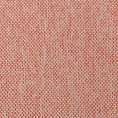 an orange and white textured fabric with small squares in the center, as well as dots